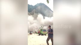 Miners run as landslide crashes down quarry in Indonesia