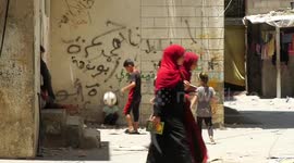 Palestinian children play between the alleys of al-Shati refugee camp on the World Refugee Day, in Gaza city