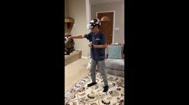 Boy TOTALLY IMMERSED in VR gameplay gets scared by prankish brother
