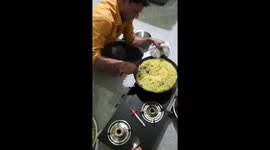 A person making Poha (indian light food) which is made by rice.