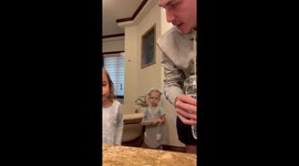 Brother splashes little sister with water in a fun prank