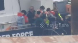 Border Force ranger returns to Dover, England, with women, children and men