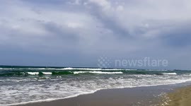 engraving with natural light, day of light and shadow, waves, shades of blue, peace, tranquility, sand, beach, sea.