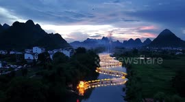 More than 50 rafts merge to create majestic 'golden dragon' on Chinese river