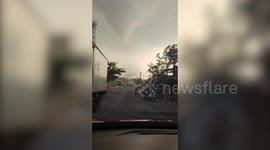 Terrifying tornado swirls above homes in the Philippines