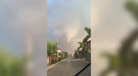 Huge funnel cloud looms over homes as tornado hits the Philippines