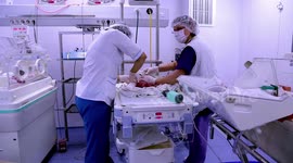 The doctors fight for the lives of the newborn babies. Small newborn babies are saved by doctors in the intensive care unit. Baby in an incubator
