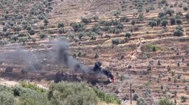 Palestinian protesters burn tires during clashes with Israeli forces following a demonstration against settlements in the village of Beita, south of Nablus in the West Bank
