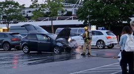 Car in fire on TESCO parking in Bristol. Fire rescue use water.