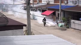 Mosquito exterminators at work on my street this morning in Pathum Thani Thailand.