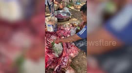 Locals rub herbs and spices on beef ribs to make exotic raw meat delicacy