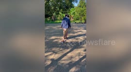 Grandmother drags along clingy pet Chihuahua as she pulls her skirt
