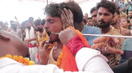 Hindu devotees have their cheeks pierced by 10-foot-long iron rod