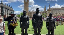 Julian Assange supporters erect Assange, Snowden and Manning statues in Parliament Square