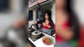 Street food cook shows off her EE cup breasts while selling coconut pancakes
