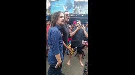 Activist protests against deforestation in the Amazon in the most violent favela in the world by piercing his tongue several times with a drill and a giant drill.