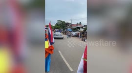 Alien cosplayer joins festival parade in spaceship-like electric vehicle