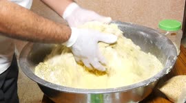 A Palestinian family prepare traditional cookies make traditional date-filled cookies in preparation for the Eid al-Adha holiday, in the northern Gaza Strip.