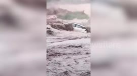 Locals risk their lives to save woman after her car got trapped in raging waters