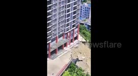 Landslide strikes adjacent to residential buildings in China
