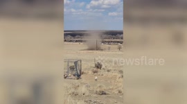 Dust devil rips through dry patch of land near train tracks in Colorado