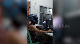 Online worker shields face with motorbike helmet as bug army plagues home