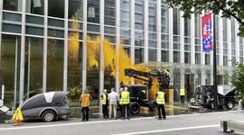 Canary Wharf Staff Seen Cleaning 10 Upper Bank Street After Protesters Spray Red Paint On The Building Wall