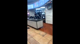 Restaurant employees serve one another with a hot hair-pulling fight