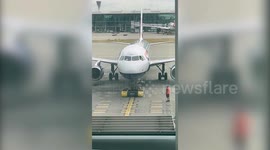 Heartwarming moment BA pilot leans from window to give passenger her passport