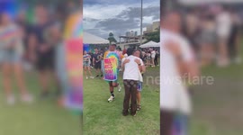 Heartwarming moment supportive mum and dad gives free hugs at Pride event