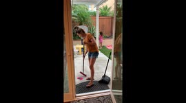 Clumsy mom almost takes daughter out with a broom before falling down herself