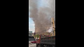 Smoke Rises From Condo Building