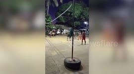 Volleyball player gets tangled in net when he smashes ball
