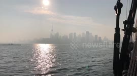 Smoke covers Toronto city skyline view from water