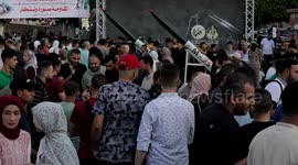 Palestinians take memorial photos with weapons belonging to the Al-Qassam Brigades, the military wing of Hamas, on the third day of Eid al-Adha in Gaza city