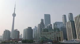 CN tower and Toronto city covered in smoke view from harbour front