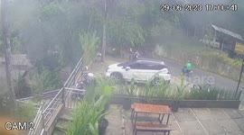 CCTV captures motorcycle slipping on diesel spill on road in Indonesia