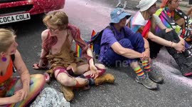 Just Stop Oil activists disrupt Coca-Cola float during London Pride, staging a protest with pink paint