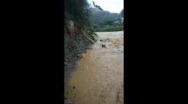 Northern Vietnam ravaged by flash floods, resulting in bridge destruction and village isolation