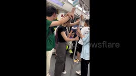 Chinese father retaliates by sitting on woman's lap in subway jostling dispute