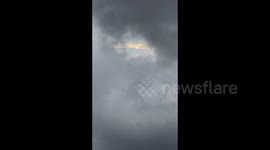 Commuters stunned as golden light resembling dragon breaks through clouds
