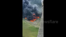 Two killed as oil tank truck falls off overpass, engulfing in flames