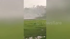 Terrifying landspout tornado rips through rice field in Thailand