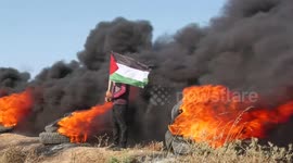Palestinian protesters burn tires during a demonstration near the fence with Isarel east of Gaza city protesting an Israeli military operation in the West Bank city of Jenin