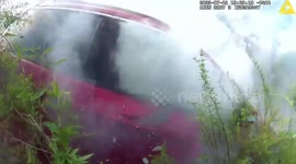 Watch moment brave US cop pulls trapped woman from burning car