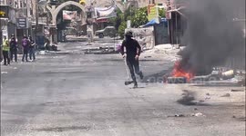 Palestinians clash with Israeli forces during an ongoing Israeli military operation in the West Bank city of Jenin