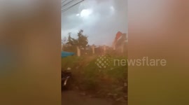 Terrifying moment family are caught in freak tornado in the Philippines