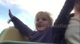Young girl experiences a rollercoaster for the first time