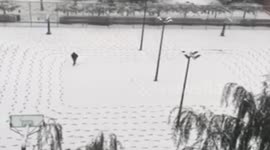Snow-covered playground is full of orderly footprints
