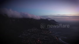 Timelapse shows clouds blow from top of Table Mountain as sun sets